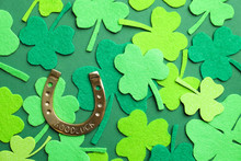 Flat Lay Composition With Clover Leaves And Horseshoe On Green Background. St. Patrick's Day