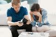 © Photographee.eu - Newly married couple sitting at home looking at their finance problems