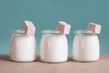 Wall Mural - three glass jars with yogurt and pink marshmallow