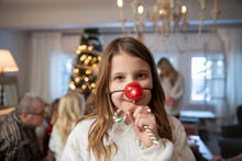 Girl With Red Plastic Nose With Extended Family On Christmas Morning