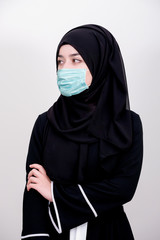 Wall Mural - Muslim girl wearing surgical mask for protection. Hijab woman take a mask for coronavirus or COVID-19 epidemic or pandemic