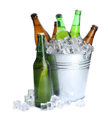 Wall Mural - Metal bucket with bottles of beer and ice cubes isolated on white