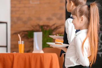 Wall Mural - Cute little waiters in restaurant