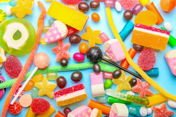 Wall Mural - Assortment of sweet candies on color background