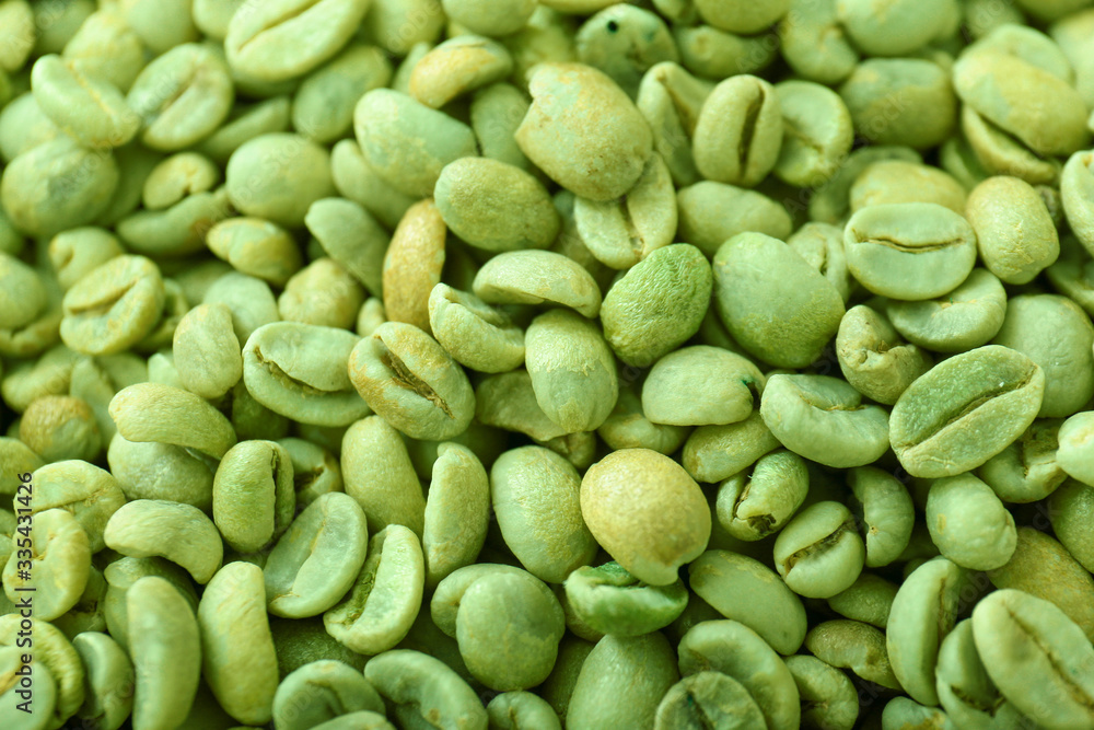 Green coffee beans as background
