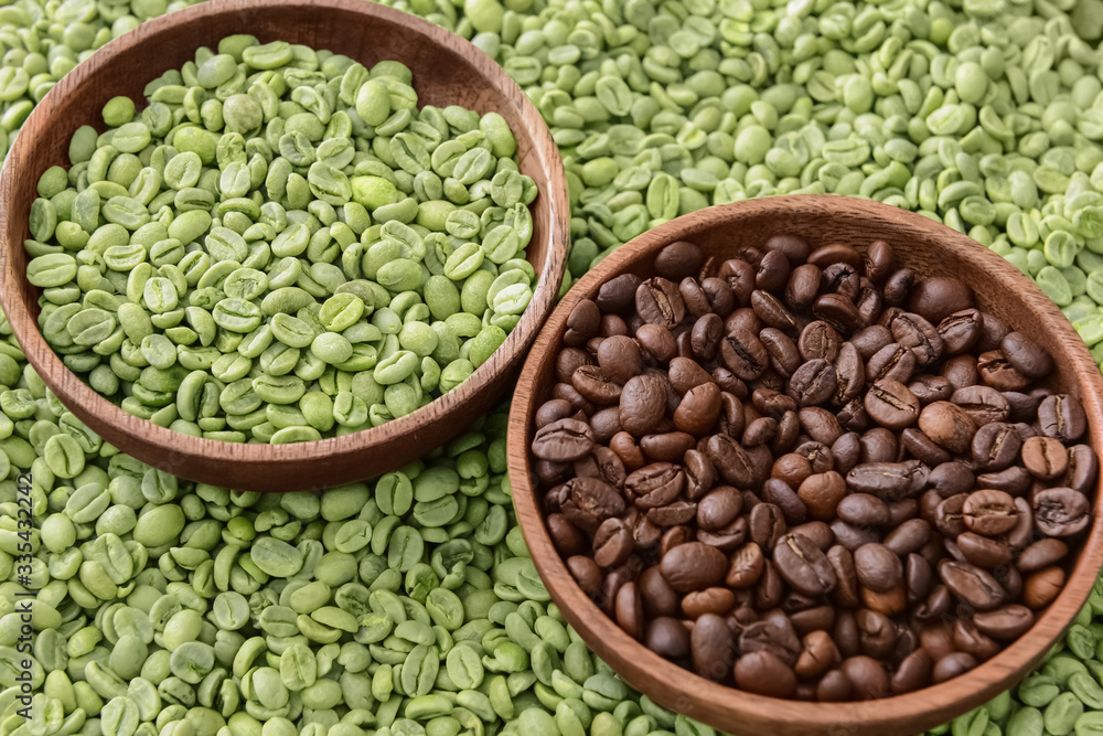 Plates with roasted and green coffee beans