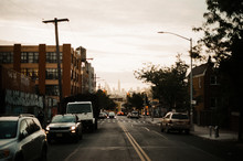 Faded Manhattan Skyline From Brooklyn Street At Sunset