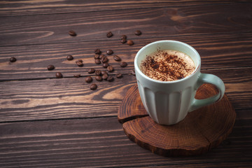 Wall Mural - Cup with coffee on a rural wooden tabletop. Latte or cappuccino with chocolate sprinkles. copy space. 