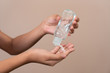 © parinya1990 - Asian girl kid using blue hand sanitizer gel in clear pump bottle , that use for killing germs, bacteria and viruses. Prevent the spread of germs and bacteria and avoid infections corona virus.