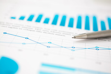 Financial statistics documents ball pen infographics at office table closeup. Internal Revenue Service inspector sum check, investigation, exchange market, earnings, savings, loan and credit concept