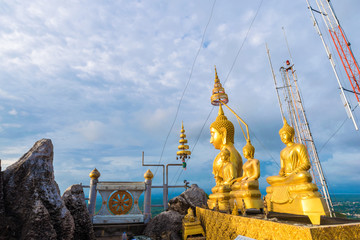 Golden statue on mountain sunruse with fog