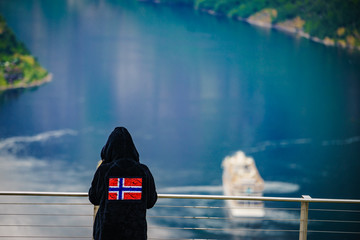 Sticker - Tourist over fjord wearing norwegian flag clothing