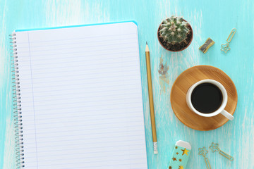 Wall Mural - top view image of open notebook with blank pages next to cup of coffee on wooden table. ready for adding text or mockup