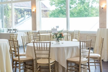 Shot of the table setting of the bright and decorated dining area of the wedding hall