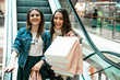 © Natalya Lys - Trade, buyers. Two beautiful girls make purchases in a shopping center, go shopping. The joy of consumption.