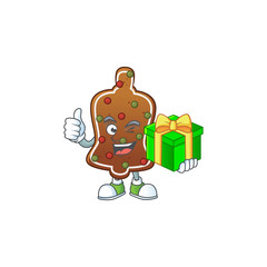 Poster - Smiley gingerbread bell cartoon character holding a gift box