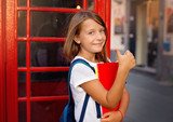 Fototapeta  - Education, school, knowledge and people concept. Cute teens girl is studying in English school