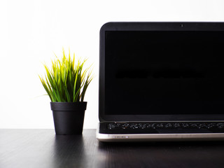 Wall Mural - mockup with a black screen for your design. laptop on the table , workplace in a minimalistic style,