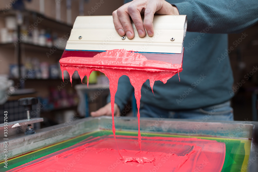 Silk screen printing. Serigraphy. Color paints and fabric. Plastisol paint and squeegee. - obrazy, fototapety, plakaty 