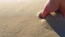 Adult Male Hand Takes Sand From Beach Close Up Slow Motion