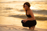 Fototapeta  - young slim beautiful woman on sunset beach, , summer vacation, sunny	