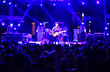 © Kiroveg - Defocused concert scene. blurred lights, stage and silhouette crowd people.