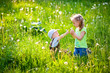 © Elena  - Happy children, brother and sister play outdoors with dandelions, at sunset. A ray of sunshine.