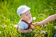© Elena  - Beautiful little boy with long hair in the park blowing dandelion at sunset. Child playing with dandelion in spring park