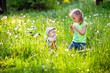 © Elena  - Happy children, brother and sister play outdoors with dandelions, at sunset. A ray of sunshine.