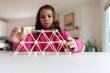 © Sarah Rypma - Young girl building a structure for a homeschool STEM project