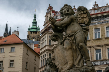 Wall Mural - Angel sculpture and St Vitus Cathedral Tower on the background, Prague