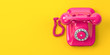 © Maksym Yemelyanov - Vintage pink telephone on yellow background.