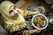 © Jasmin Merdan - Muslim woman serving iftar on table for gathering family