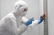 © Parilov - Concept coronavirus disinfection. People in hazmats making cleaning in lift apartment