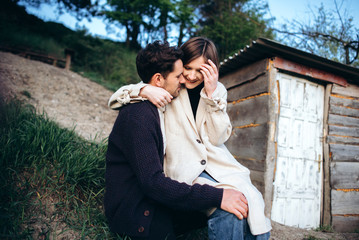 Young hipster couple in love with boyfriend and girl walking near rocks and forest. Have fun on vacation at sunset