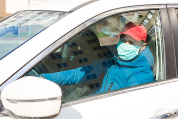 Coronavirus protection.Taxi driver in a protective mask and gloves. Concept: Stop: Covid-19