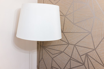 Wall Mural - Closeup of white lamp light in bedroom or living room decoration with geometric patterns in corner wall of house or apartment hotel