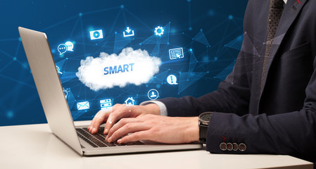 businessman working on laptop with smart inscription, modern technology concept