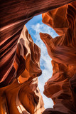 Fototapeta  - Light from above coming through to the curvy red walls of the Lower Antelope Canyon in Page Arizona USA