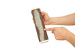 Hand holding dirty water filter cartridge on white isolated background