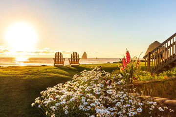 Two chairs at the beach ready to watch the sunset.