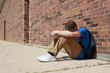 © soupstock - Depressed upset teenage student sitting outside school