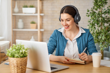 Woman working on a laptop.