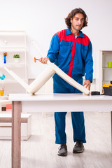 Young male carpenter working indoors