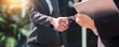 © khwanchai - successful negotiate and handshake concept, two businessman shake hand with partner to celebration partnership and teamwork, business deal