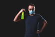 © astrosystem - Person with protective antiviral mask, chemical decontamination sprayer bottle in home isolation.