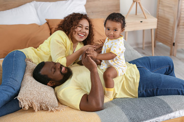 Sticker - Happy African-American parents with cute baby at home