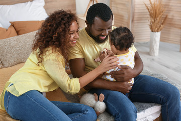 Sticker - Happy African-American parents with cute baby at home