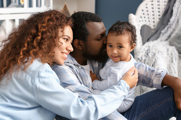 Sticker - Happy African-American parents with cute baby at home