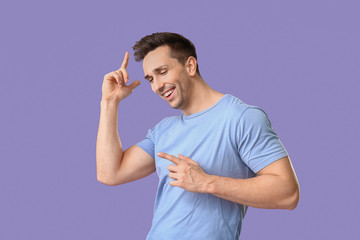 Wall Mural - Cool young man dancing against color background